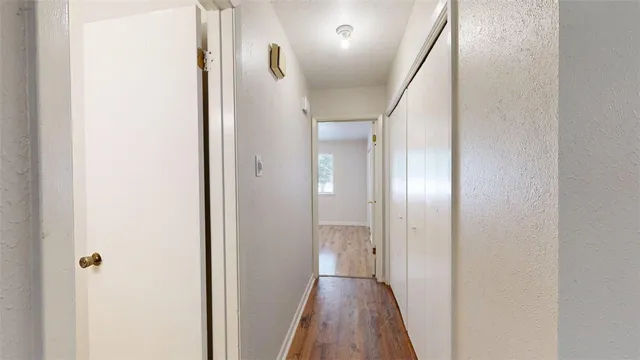 a view of a hallway with wooden floor