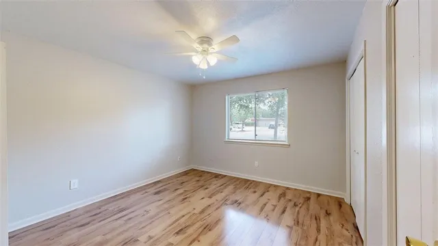 wooden floor in an empty room with a window