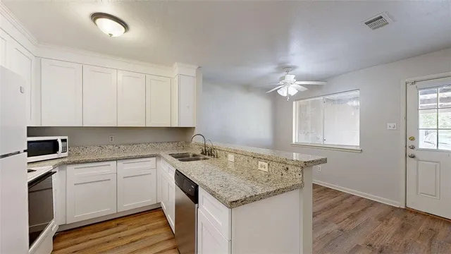a kitchen that has a sink and a stove in it