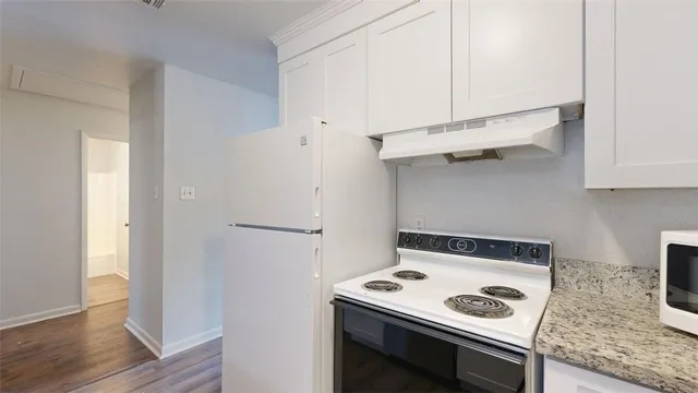 a kitchen with a stove and a refrigerator
