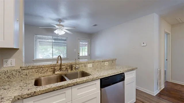 a kitchen with a sink cabinets a window and appliances