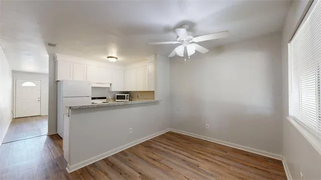 a view of kitchen with sink microwave and stove