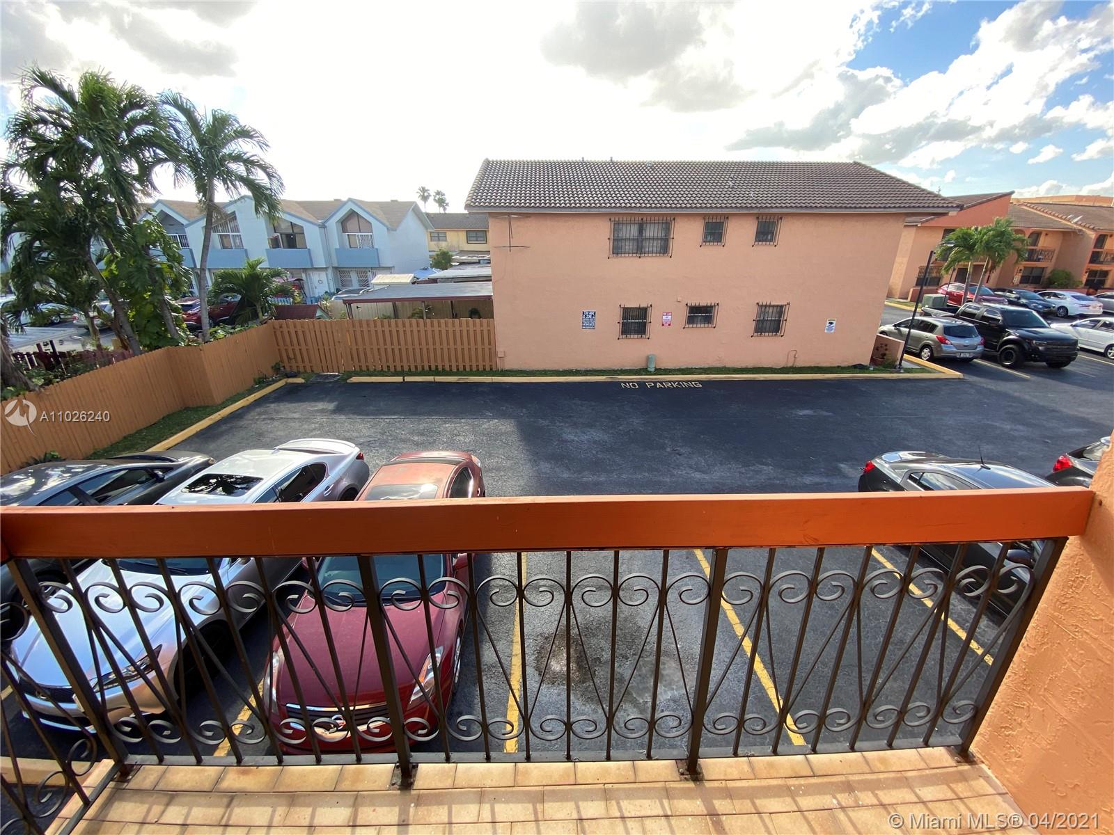 a view of building with car parked