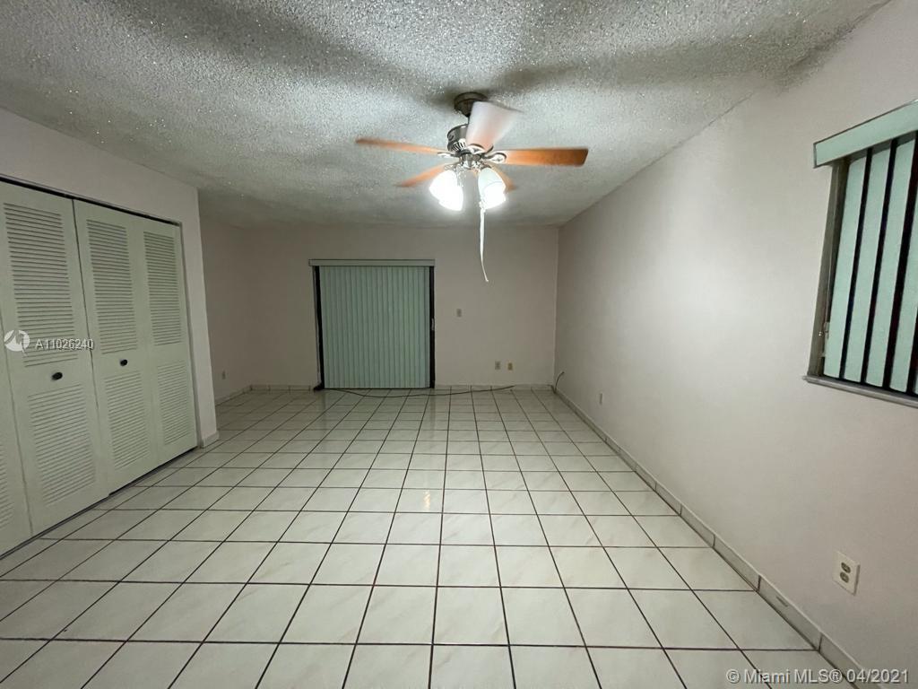 5900 West 18th Avenue, Unit A14 Hialeah, FL 33012 - Photo 12 of 29 an empty room with windows and fan