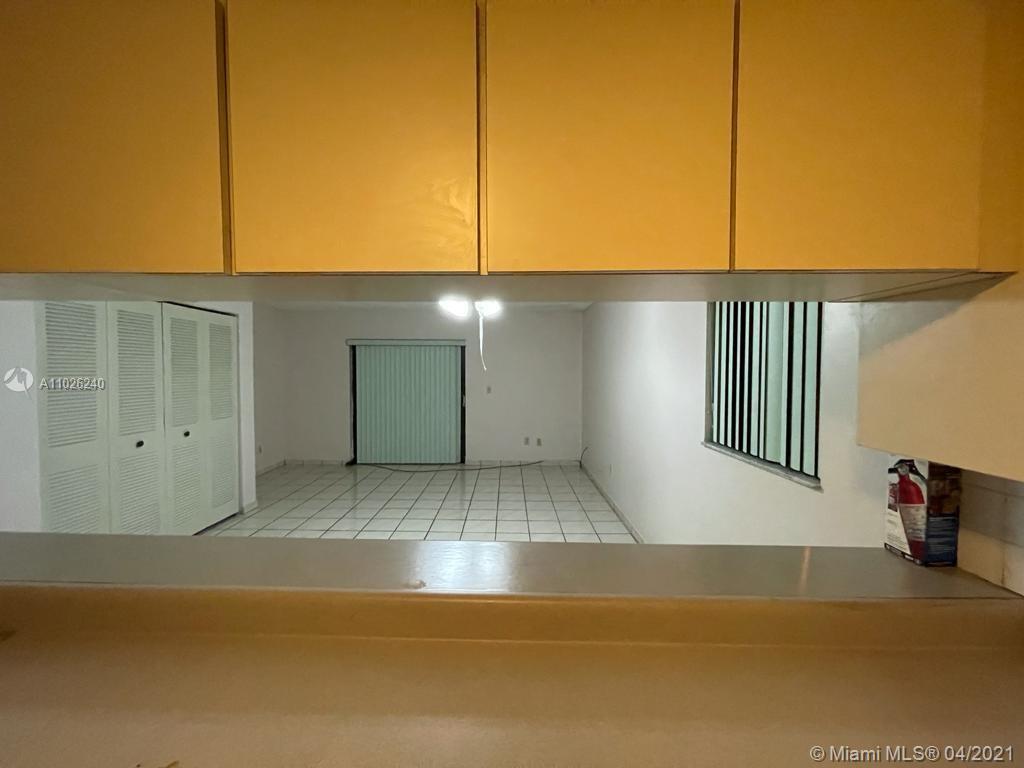 5900 West 18th Avenue, Unit A14 Hialeah, FL 33012 - Photo 14 of 29 a view of an empty room with windows
