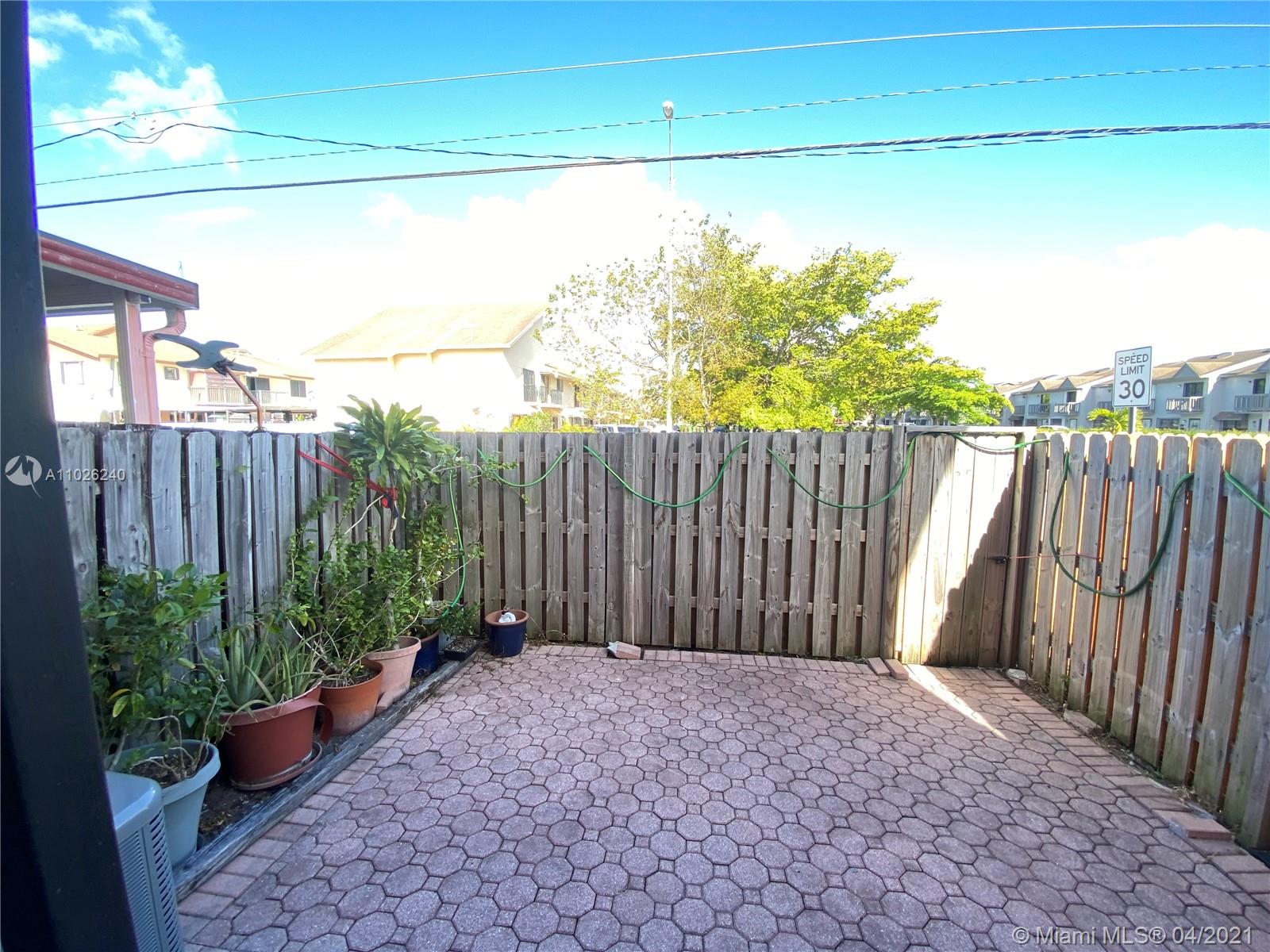 5900 West 18th Avenue, Unit A14 Hialeah, FL 33012 - Photo 18 of 29 a backyard of a house with lots of green space