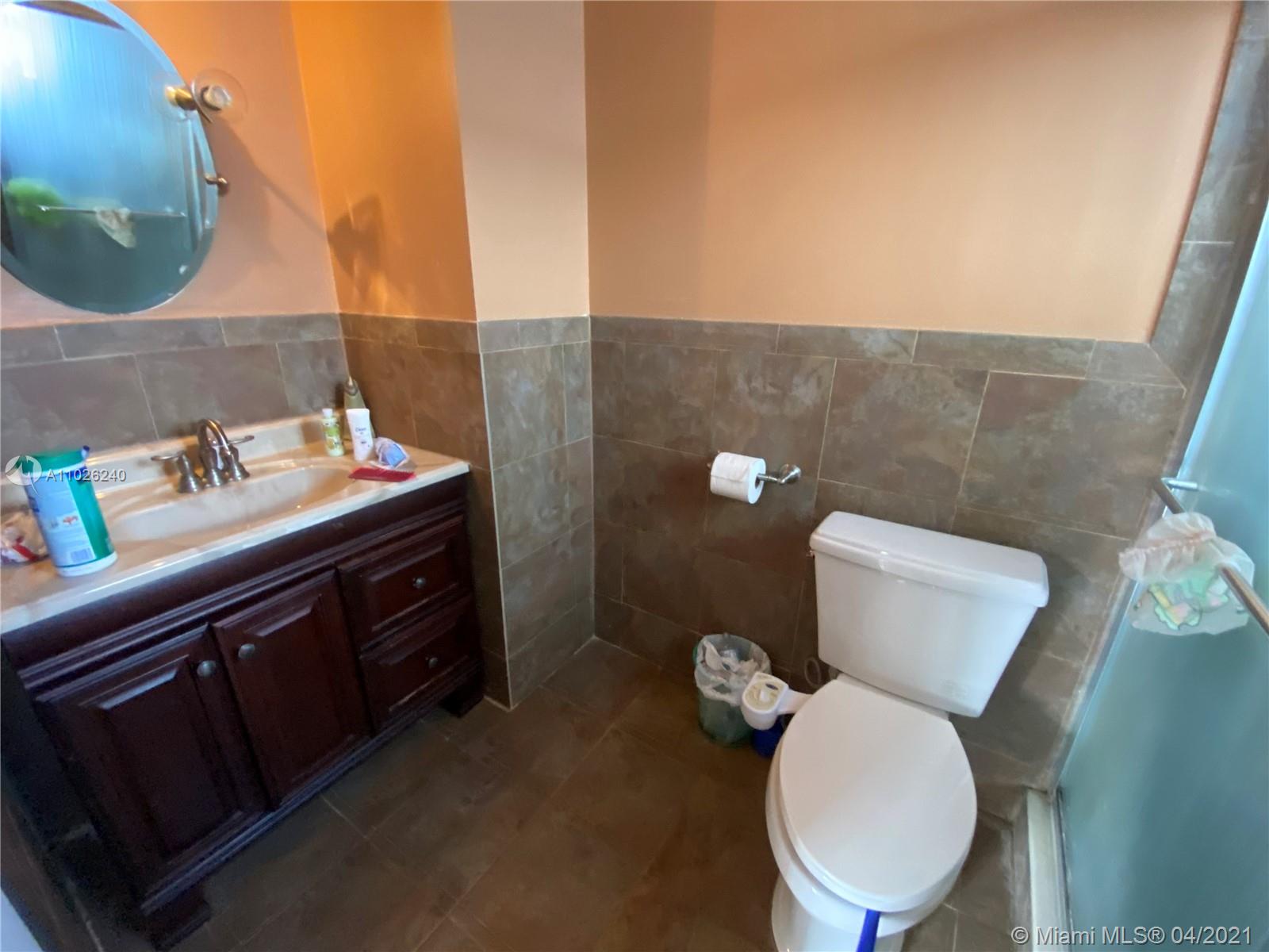 5900 West 18th Avenue, Unit A14 Hialeah, FL 33012 - Photo 19 of 29 a bathroom with a toilet sink and mirror