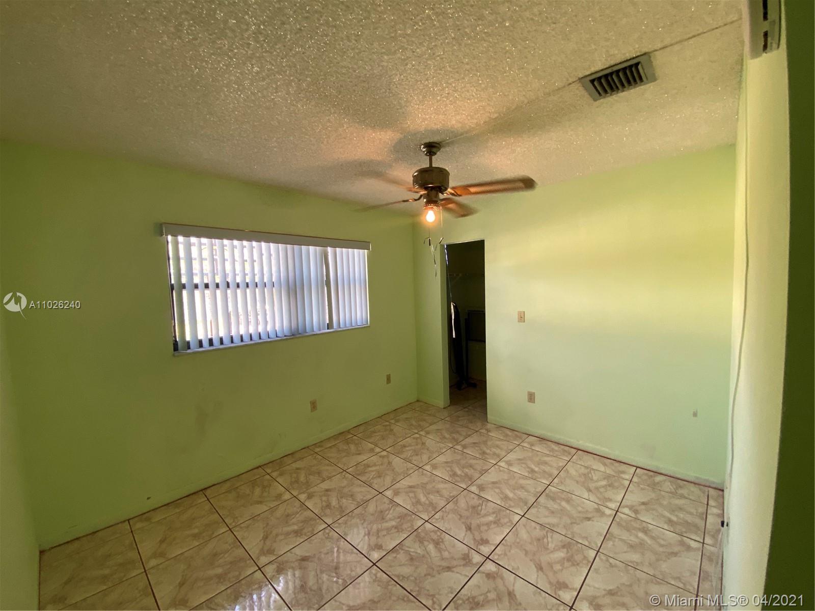 5900 West 18th Avenue, Unit A14 Hialeah, FL 33012 - Photo 20 of 29 a view of an empty room with a window