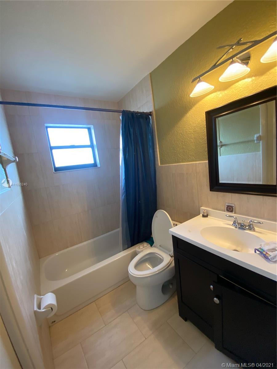 5900 West 18th Avenue, Unit A14 Hialeah, FL 33012 - Photo 22 of 29 a bathroom with a sink a toilet and shower
