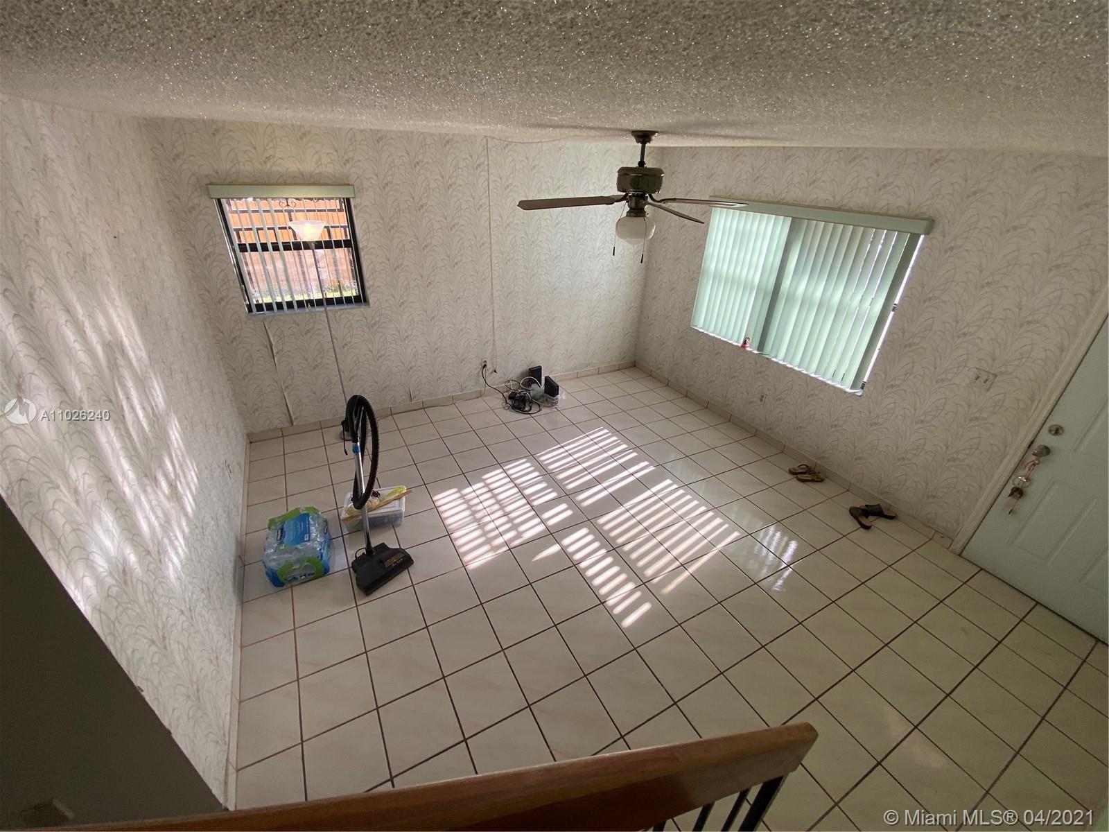5900 West 18th Avenue, Unit A14 Hialeah, FL 33012 - Photo 28 of 29 a bedroom with a bed and a window