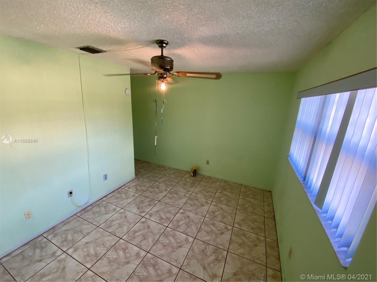 5900 West 18th Avenue, Unit A14 Hialeah, FL 33012 - Photo 29 of 29 a view of an empty room with a window