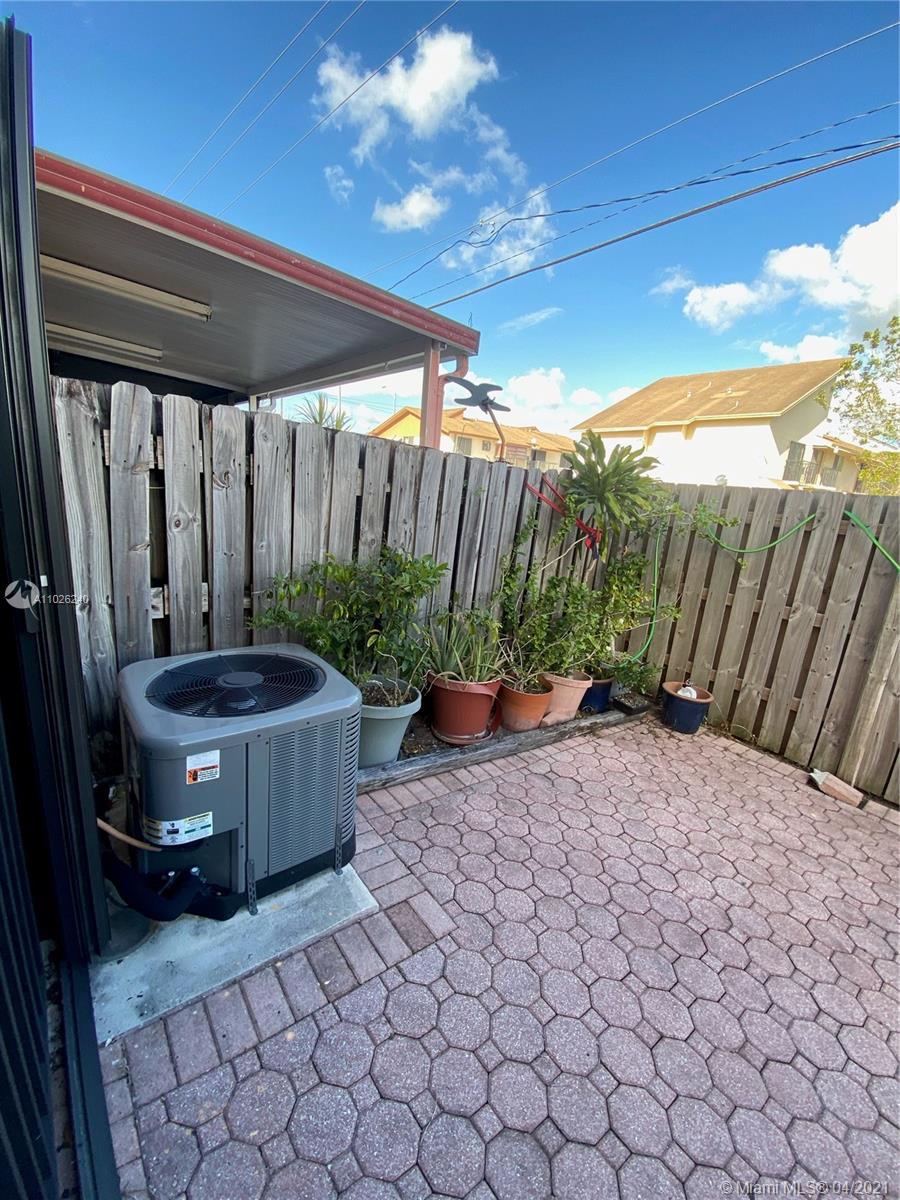5900 West 18th Avenue, Unit A14 Hialeah, FL 33012 - Photo 5 of 29 a view of a backyard with plants and outdoor seating