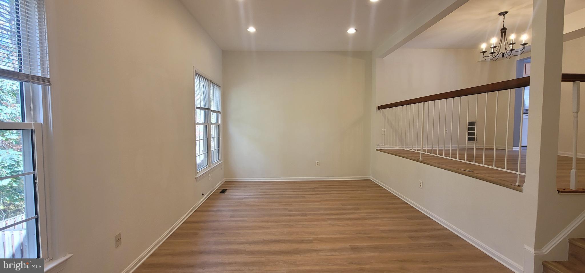 7 Plum Grove Way Gaithersburg, MD 20878 - Photo 11 of 46 a view of a hallway with wooden floor and staircase