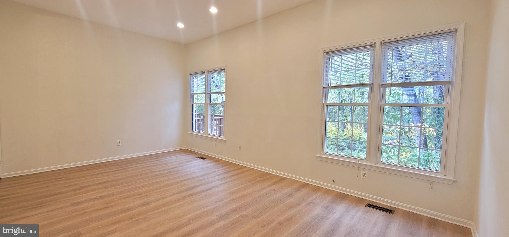 7 Plum Grove Way Gaithersburg, MD 20878 - Photo 12 of 46 an empty room with wooden floor and windows