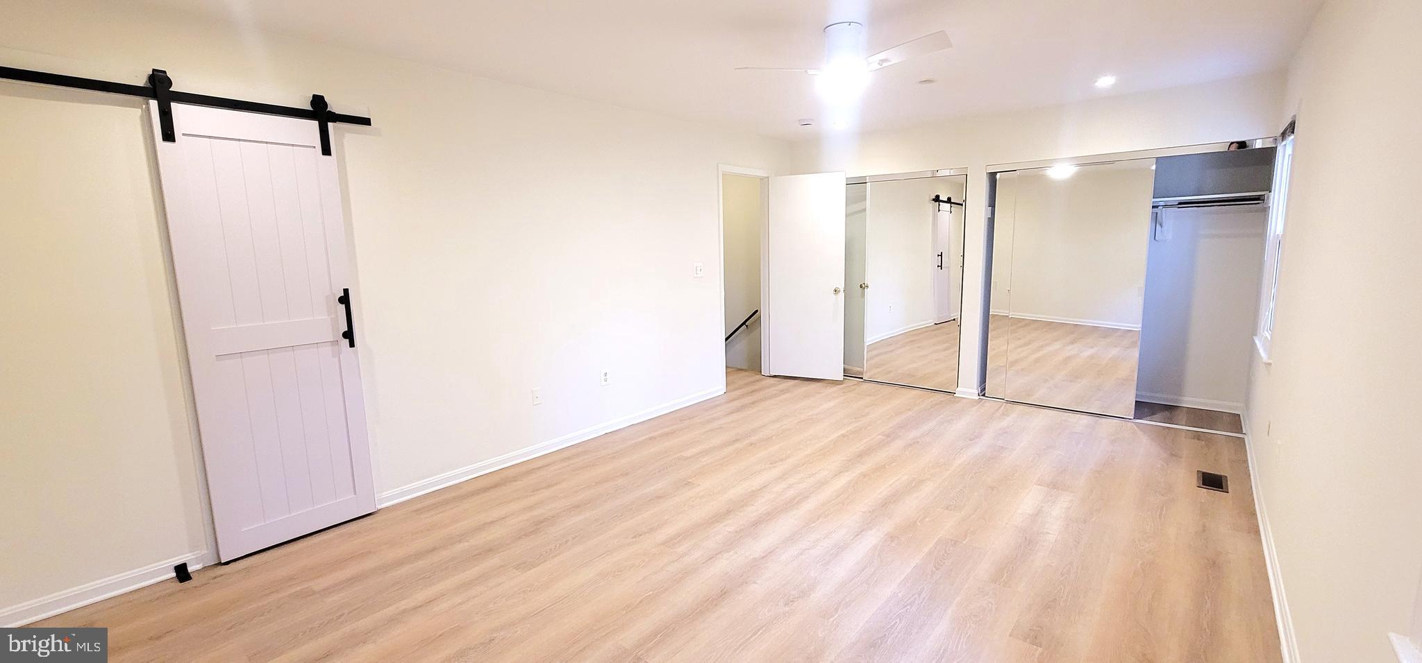 7 Plum Grove Way Gaithersburg, MD 20878 - Photo 17 of 46 a view of empty room with wooden floor and fan