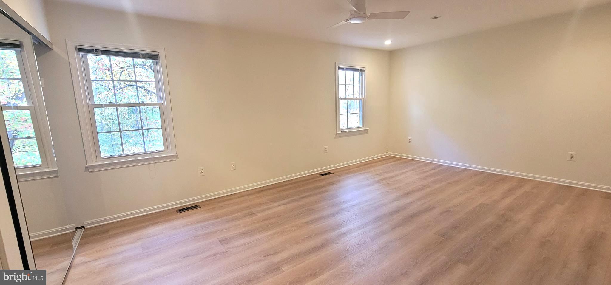 7 Plum Grove Way Gaithersburg, MD 20878 - Photo 20 of 46 an empty room with wooden floor and windows