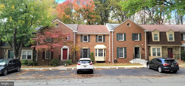 a car parked in front of a brick house