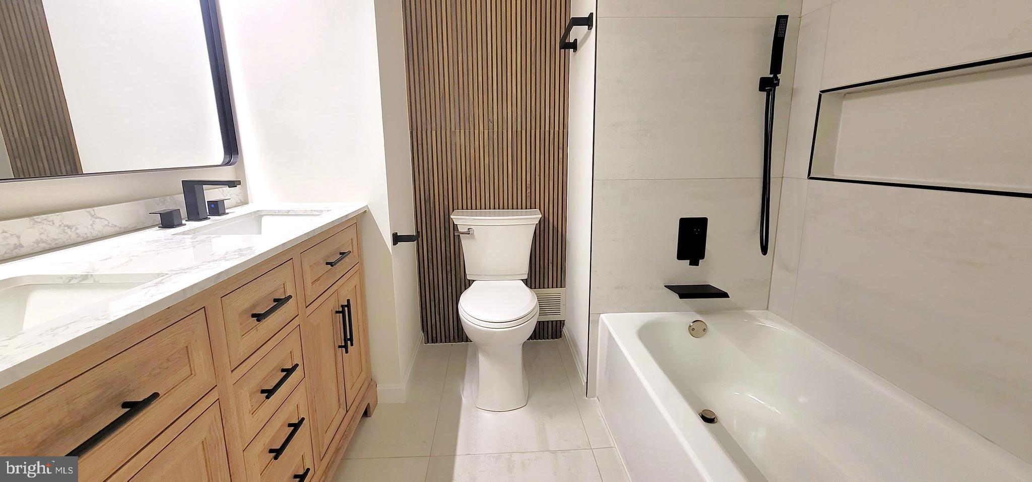 7 Plum Grove Way Gaithersburg, MD 20878 - Photo 21 of 46 a bathroom with a granite countertop sink a toilet and a bathtub