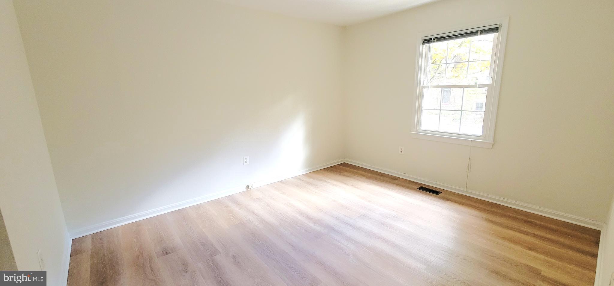 7 Plum Grove Way Gaithersburg, MD 20878 - Photo 26 of 46 an empty room with wooden floor and windows