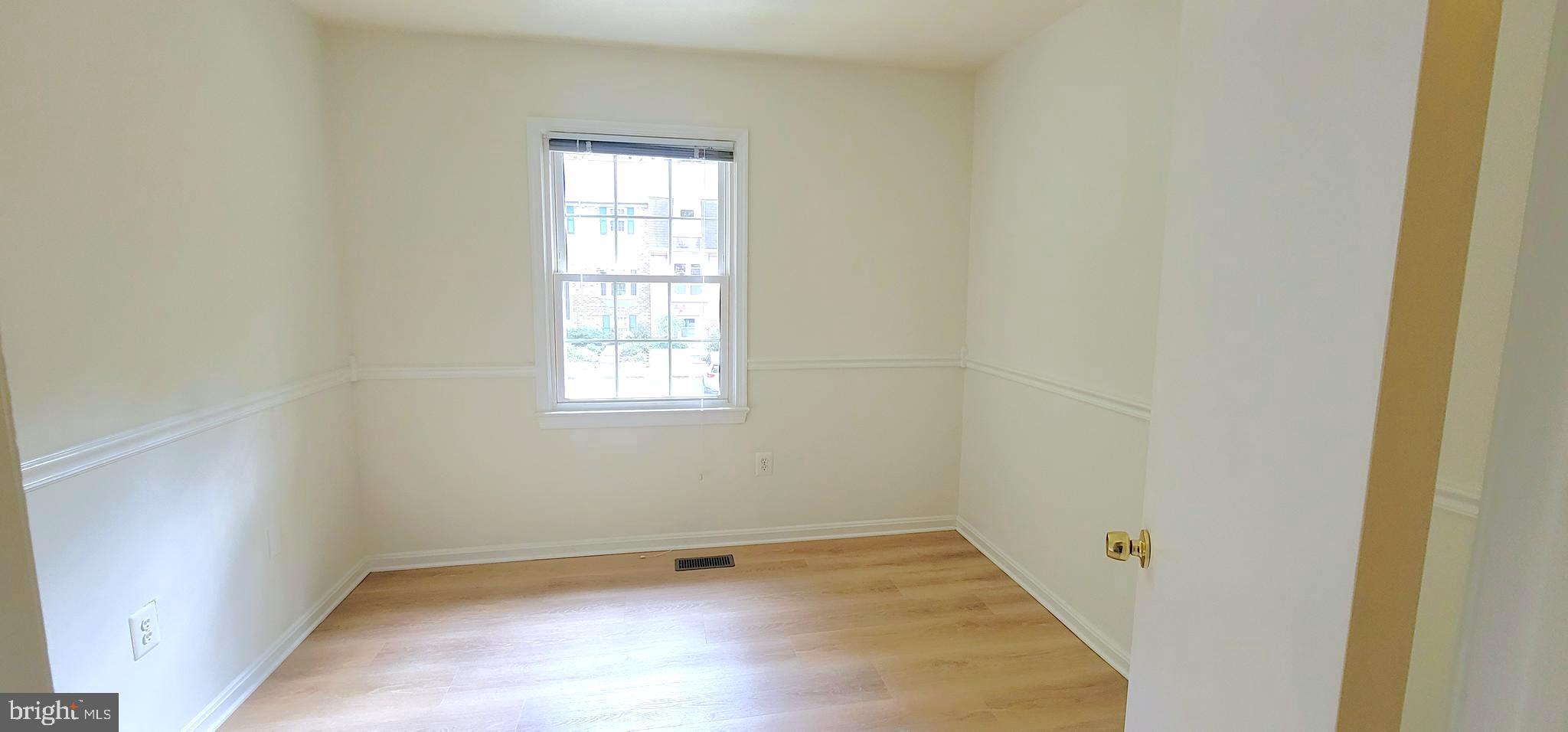 7 Plum Grove Way Gaithersburg, MD 20878 - Photo 28 of 46 a view of a small space with wooden floor and a window