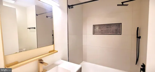 a bathroom with a bathtub and a sink