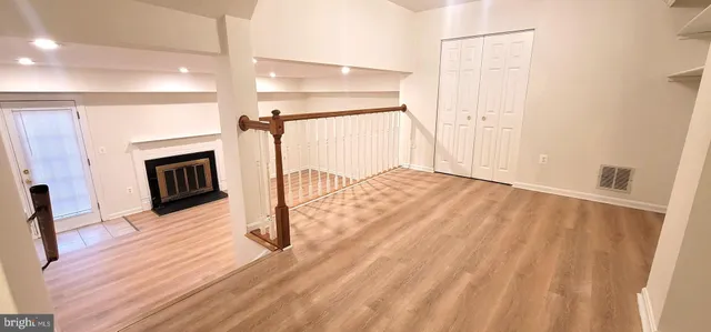 a view of a livingroom with wooden floor and fireplace