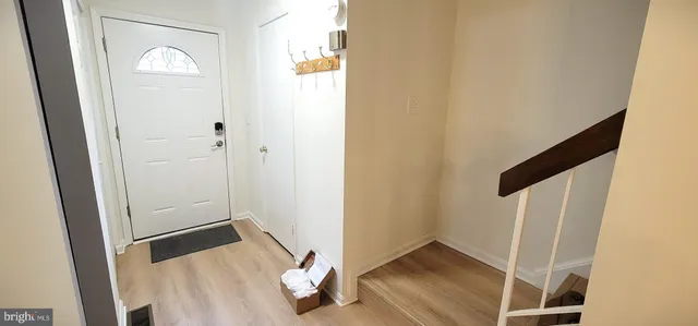 a view of front door with wooden floor
