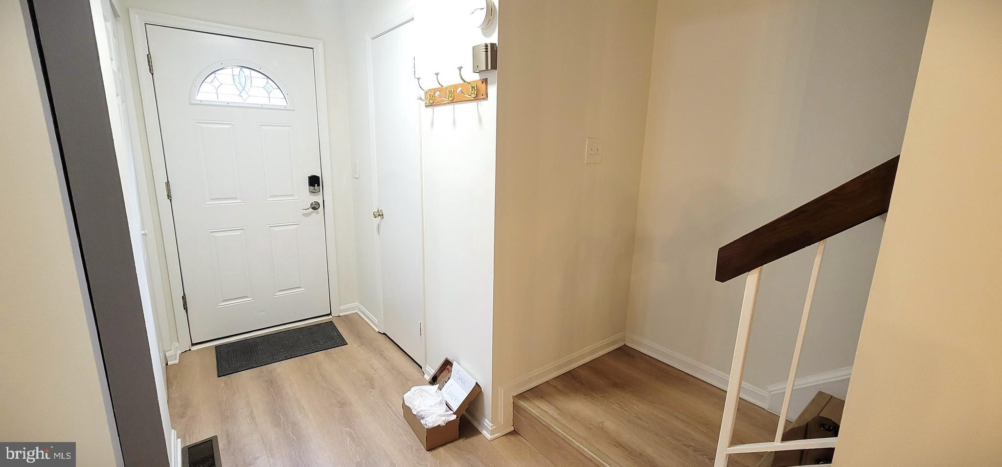 7 Plum Grove Way Gaithersburg, MD 20878 - Photo 4 of 46 a view of front door with wooden floor