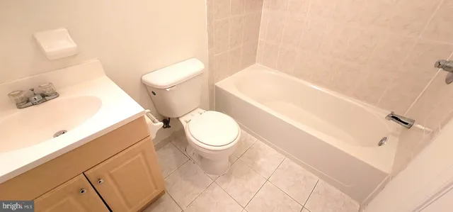 a white toilet sitting next to a bathroom sink