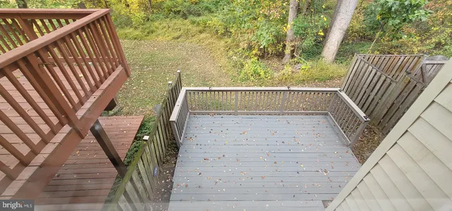 a view of balcony with wooden floor and a bench