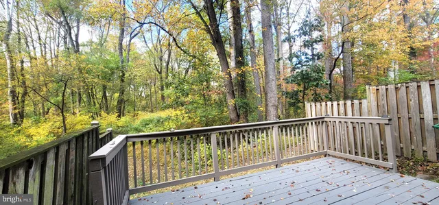 a view of balcony with wooden fence and floor