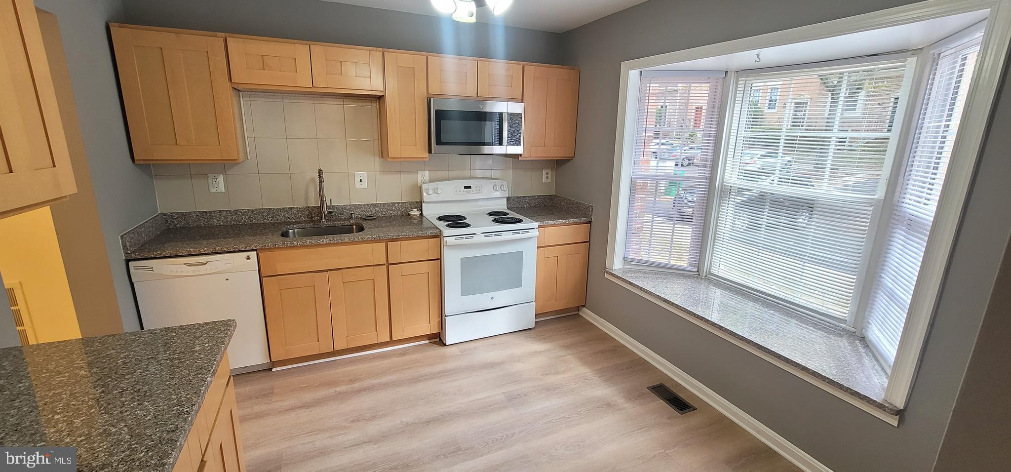 7 Plum Grove Way Gaithersburg, MD 20878 - Photo 6 of 46 a kitchen with stainless steel appliances granite countertop a stove a sink and a refrigerator