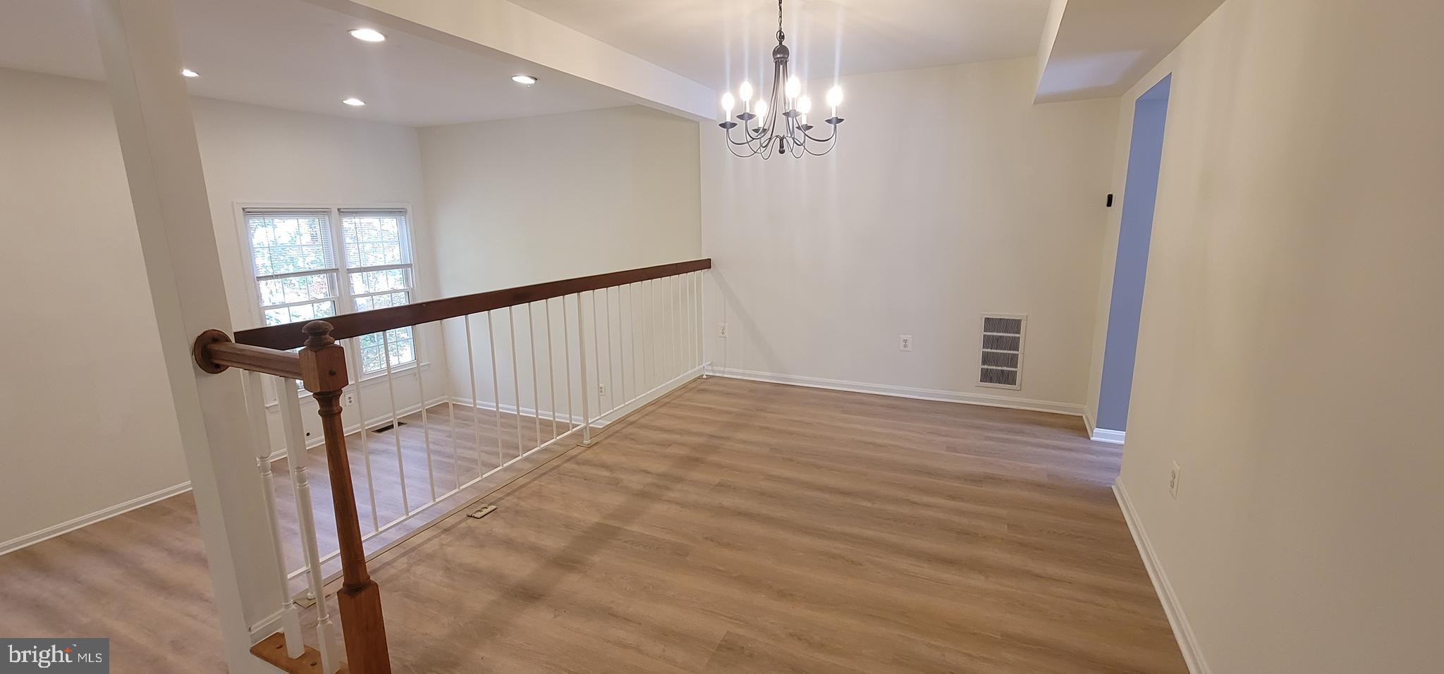 7 Plum Grove Way Gaithersburg, MD 20878 - Photo 9 of 46 a view of empty room with wooden floor