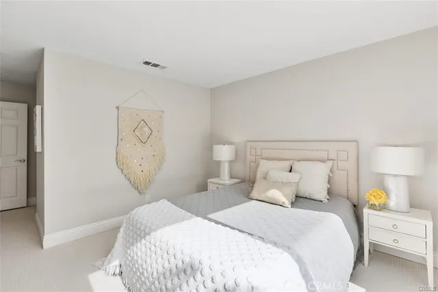 a bedroom with bed and wall painting