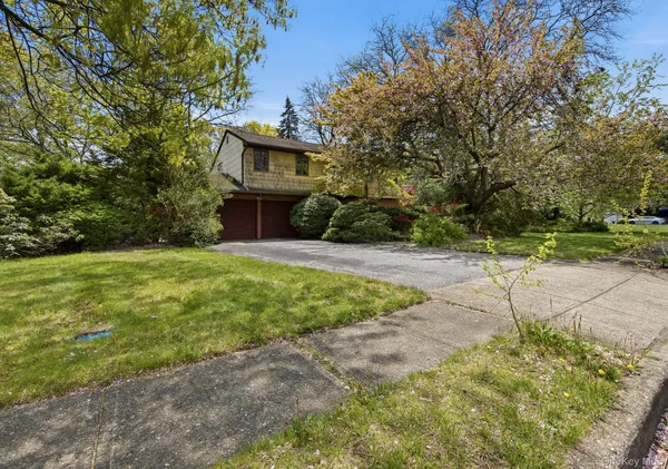 a view of an house with backyard space and garden