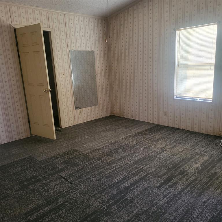 548 Highway 69 Point, TX 75472 - Photo 12 of 22 an empty room with wooden floor and a window
