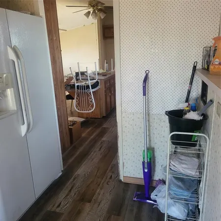 a view of a hallway with wooden floor and stairs