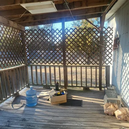 a view of patio with a table and chairs