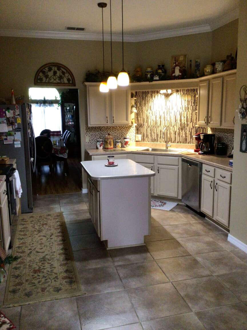 100 Cedar Place Freeport, FL 32439 - Photo 8 of 9 a kitchen with a sink a counter top space appliances and cabinets