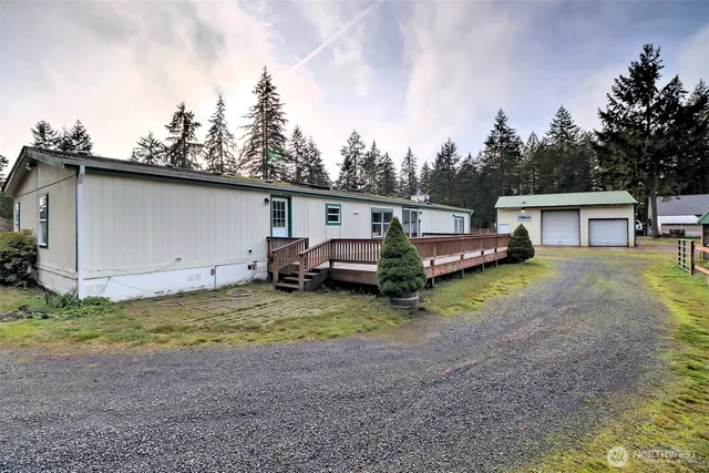 a view of a house with backyard and utility room