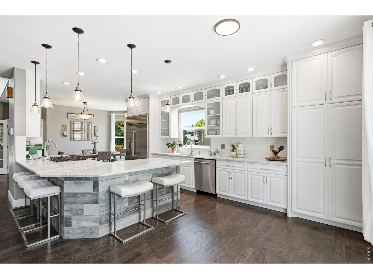 11725 Pleasant Hill Road Longmont, CO 80504 - Photo 11 of 50 Updated counters, fresh paint, subway tile backsplash, stainless steel appliances, modern accent lighting, ample workspace, and a large window over the sink