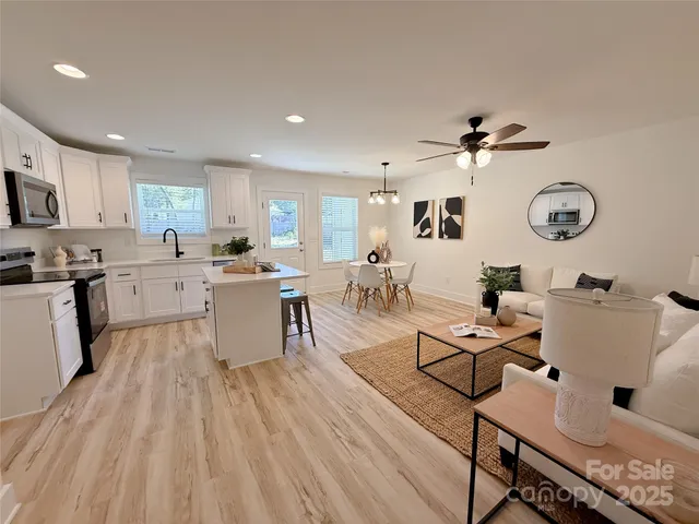 a large bed sitting in a bedroom next to a window