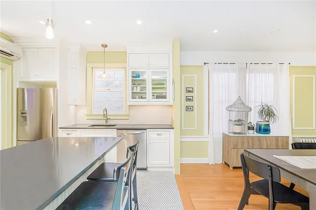a large kitchen with a table and chairs in it