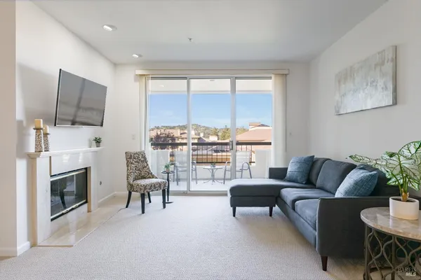 a living room with furniture a fireplace and a flat screen tv