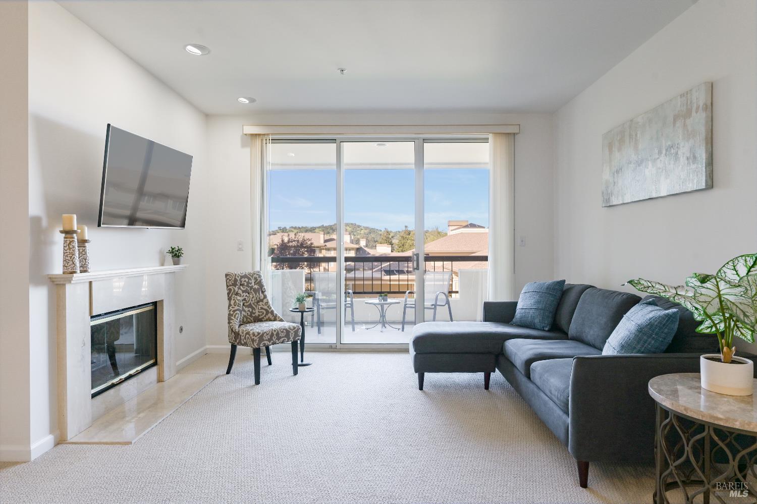 400 Deer Valley Road, Unit 3D San Rafael, CA 94903 - Photo 1 of 18 a living room with furniture a fireplace and a flat screen tv
