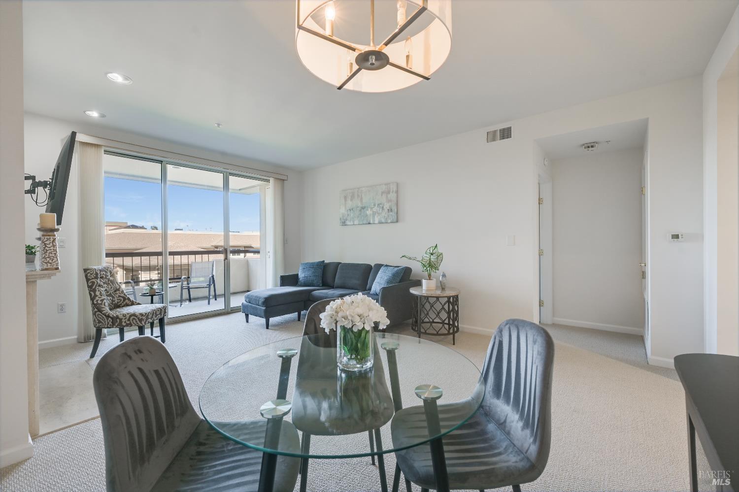 400 Deer Valley Road, Unit 3D San Rafael, CA 94903 - Photo 2 of 18 a view of a dining room with furniture wooden floor and chandelier