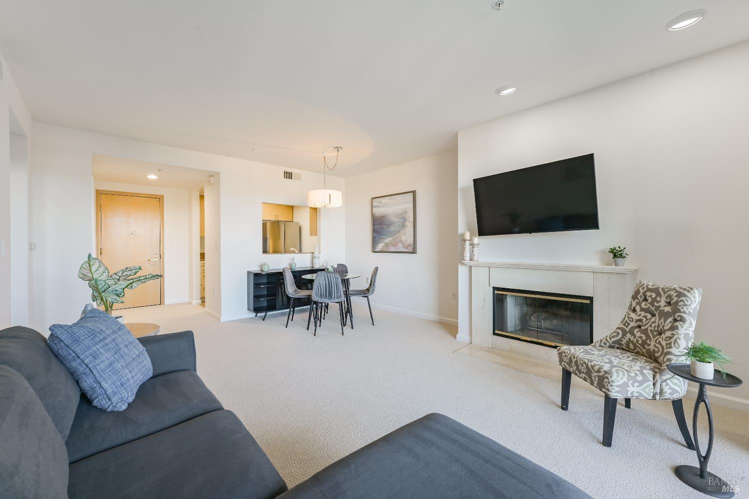 400 Deer Valley Road, Unit 3D San Rafael, CA 94903 - Photo 4 of 18 a living room with furniture a fireplace and a flat screen tv