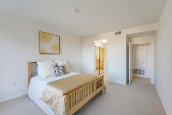 a bedroom with a bed and a view of bathroom