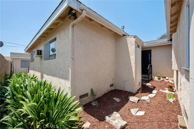 a backyard of a house with potted plants