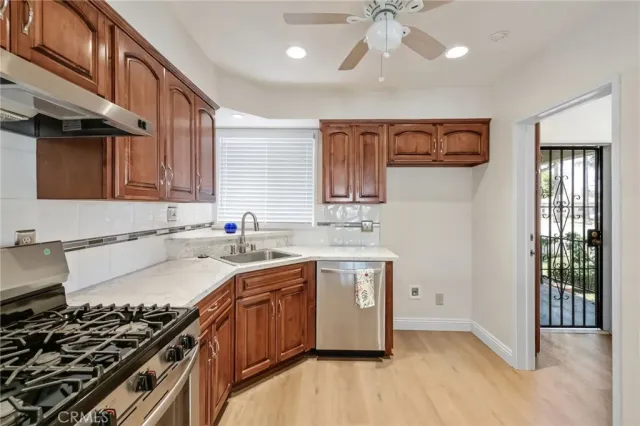a kitchen with stainless steel appliances a sink stove and cabinets